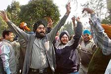 Supporters of the Shiromani Akali Dal (Delhi) headed by Paramjit Singh Sarna celebrate after the party retained majority in the 46-member Delhi Sikh Gurdwara Management Committee elections in New Delhi on Tuesday