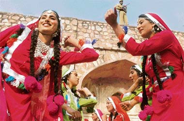 NACH KUDIYE: Folk dancers from Barnala presents the sammi dance at a press preview of the Lok Tarang National Folk Dance Festival 2007 while a security person keeps vigil in the Capital