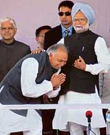 Mr Surinder Singla, Congress candidate for the Amritsar Lok Sabha seat seeks the blessings of Prime Minister Manmohan Singh at an election rally in Amritsar on Monday. 