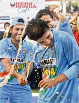 Mahendra Singh Dhoni  and Irfan Pathan pour soft drinks on Man of the Series Sourav Ganguly against Sri Lanka in Visakhapatnam