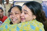 A Pakistani relative hugs a survivor as she arrives from India at Cantt Railway Station in Karachi