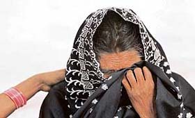 A relative of a victim, who was injured in blasts on the Samjhauta Express train, is consoled by a woman outside a hospital in New Delhi
