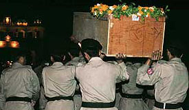 Rangers carry the coffin of a Pakistani victim of the twin bomb blasts in the Samjhauta Express in the wee hours of Thursday at the Wagah joint checkpost. 