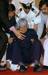 President A.P.J. Abdul Kalam is helped by his aides after he fell at the Sangeet Natak Akademi award-presentation ceremony in New Delhi on Thursday