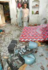 A Dalit couple at Saalwan village show their household items burnt by miscreants of the village on Thursday