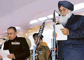 Parkash Singh Badal being administered the oath of office as Chief Minister by Punjab Governor Gen S.F. Rodrigues (retd) at the PCA Stadium in Mohali.