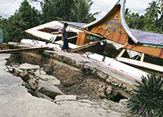 A boy walks through the wreckage of a restaurant in Solok town after being rocked by strong earthquakes in West Sumatra province on Tuesday.