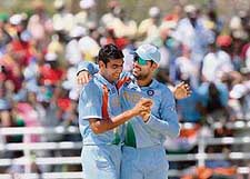 Yuvraj Singh congratulates Munaf Patel for the wicket of D.R. Smith of the West Indies during their warm-up match in Trelawny on Friday