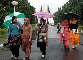 Girls walk leisurely as it rains in Patiala on Monday.