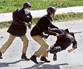 Policemen beat a lawyer during a protest against the sacking of the Chief Justice in Islamabad on Friday.