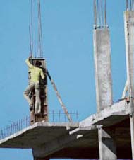 A man shapes up iron bars at a construction site in Chandigarh. Driven by the strong economic growth and high FDI flow, the upward trend in the prices of domestic real estate market will resume over the next four to six months, even as a correction of up to 10-15 per cent is inevitable, according to a FICCI study.