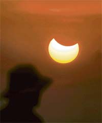 A person witnesses the partial solar eclipse in New Delhi on Monday morning