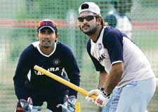 Dinesh Karthik and Mahendra Singh Dhoni during a training session in Couva on Wednesday