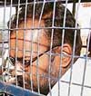Pawan Mittal alias Monu, prime accused in the Manjunath murder case, is brought to be produced at the district court in Lakhimpur Kheri on Friday. 