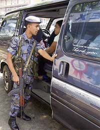 A Sri Lankan air force soldier checks the interior of a vehicle at a checkpoint outside Air Force Headquarters in Colombo
