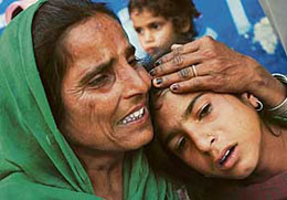 Relatives wail as they wait for the bodies of the five labourers killed by militants in Thiriat village of Rajouri district in Jammu and Kashmir on Friday. 