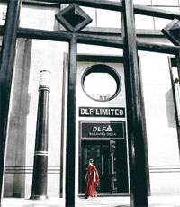 A woman leaves the offices of real estate developer DLF in New Delhi.