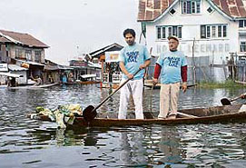 Two men in T-shirts bearing the slogan "Save the Dal" participate in a clean-up operation on the famous Dal Lake in Srinagar on Sunday. The world famous Dal Lake is becoming increasingly polluted due to negligence, illegal construction and encroachments.