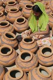 DEXTROUS HANDS: With the onset of summer, this woman is busy giving final touches to the earthen pots in Amritsar.