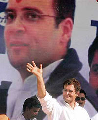 Congress MP from Amethi Rahul Gandhi waves at the crowd during a public meeting at Bharthana in Etawa.
