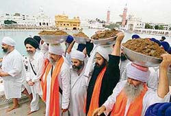 Devotees, led by Giani Jaswant Singh, offer kar sewa for repair work at the Golden Temple in Amritsar