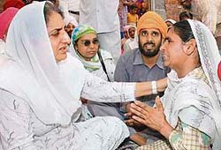 Leader of the opposition Rajinder Kaur Bhattal consoles family members of Ranjit Singh, who was allegedly killed by SAD workers, at Jijeani village in the Majitha constituency of Amritsar district