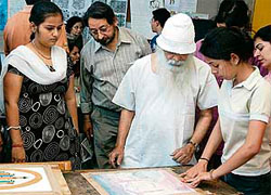 S.B. Seth Sumanav (centre) guides students in wash painting technique at Government College of Art in Chandigarh.