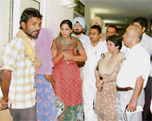 Chairperson of the Punjab State Women Commission Parminder Kaur talks to the parents of Sandeep Kaur, one of the injured girls in the acid attack case, at a hospital in Ludhiana.