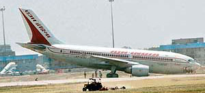 An Air India plane lies nose down at IGI Airport in New Delhi.