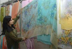 GETTING ARTY: A woman takes a look at the painted dujpatta at an exhibition in Amritsar on Tuesday.