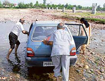A vehicle gets stuck in Bhag Nullah near Mukandpur Chaudhria in Kathua district of Jammu and Kashmir.