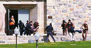 Injured occupants being carried out of Norris Hall at Virginia Tech in Blacksburg, Va., on Monday. A gunman opened fire in a dormitory and classroom at Virginia Tech on Monday, killing 22 persons.
