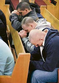 Members of Virginia Tech's Corp of Cadets pray in the War memorial Chapel hours after a gunman shot dead 33 persons in a shooting spree at the university in Blacksburg, Virginia