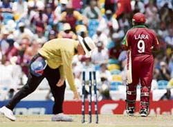 LARAs RUN ENDS: Umpire Rudi Koertzen picks the bails up while West Indies captain Brian Lara walks off after being run out against England during the Super-Eight ICC World Cup cricket match at the Kensington Oval in Bridgetown