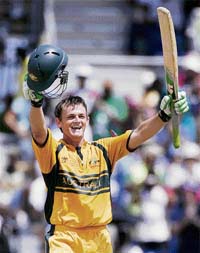 Australia’s Adam Gilchrist raises his bat after completing his century during the World Cup final against Sri Lanka at the Kensington Oval in Bridgetown on Saturday.