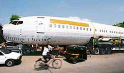 The fuselage of a Boeing 737 is parked on a road in Mumbai on Thursday. The trailer, carrying the fuselage, got stuck on the narrow road while being taken to New Delhi.