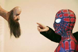 A visitor points at a sculpture of a bearded man and Spiderman at Australian artist Stephen Birch’s show in Sydney