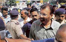 DIG (Border Range) D.G. Vanzara (front), superintendent of police (Intelligence Bureau) Rajkumar Pandiyan (centre) and Rajasthan IPS officer Dinesh Kumar (left) being taken to the metropolitan court in Ahmedabad