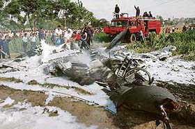 Air Force personnel spray foam on the wreckage of MiG 29 that had crashed at Daroli Khurd village, near Adampur Air Force Station