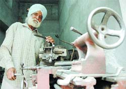 Parwinder Pritam, a Punjabi poet, works at his lathe in the walled city area of Amritsar.