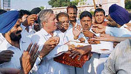 BSP supporters distribute sweets in Amritsar on Friday to celebrate the victory of their party in the UP Assembly elections.