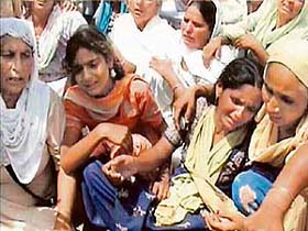 Relatives console Shinghara Singh's widow Balwinder Kaur and her daughter Gurpreet Kaur at their residence in Thakarpura village on the Indo-Pak border, 20 km from Gurdaspur
