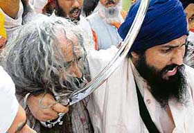 A Sikh devotee grabs an ASI by the neck at a meeting of the Akal Takht Secretariat in Amritsar