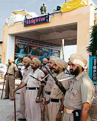 Punjab Police and BSF personnel stand guard at the Sirsa-based Dera Sacha Sauda branch at Salabatpura