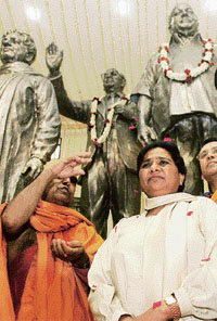 After throwing enough hints that she was ready to do business with the ruling alliance, Uttar Pradesh Chief Minister Mayawati (being felicitated in the picture) today met Congress president Sonia Gandhi, but kept her partys cards to herself on presidential candidate.