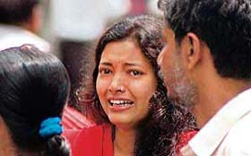 A relative of a blast victim weeps after a powerful bomb went off in the Anthgaon area of Guwahati