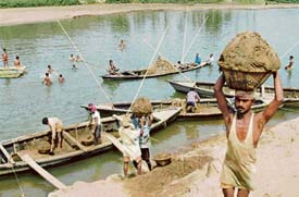 Labourers collect sand from the River Gumti at Sunamura, 70 km south of Agartala, to be used in construction sector. Foreign direct investment in India during 2006-07 stood at $16 billion and the construction and real estate sectors together received $1.45 billion out of this, according to information filed in Parliament.