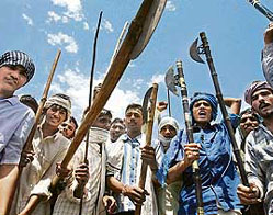 Protesters from the Gujjar community shout slogans in Sikandra, Rajasthan, on Saturday. Demanding special government privileges, they blocked roads and damaged railway tracks, stranding thousands on the fifth day of protests that has killed 23 persons.