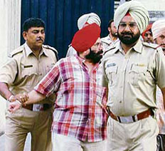 B.I.S. Chahal being whisked away by the Ludhiana police from the Vigilance office in Ludhiana on Sunday.