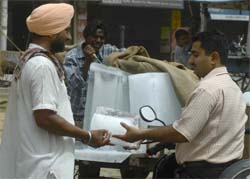 A resident buys ice from a vendor as his refrigerator remains non-functional due to long power cuts.